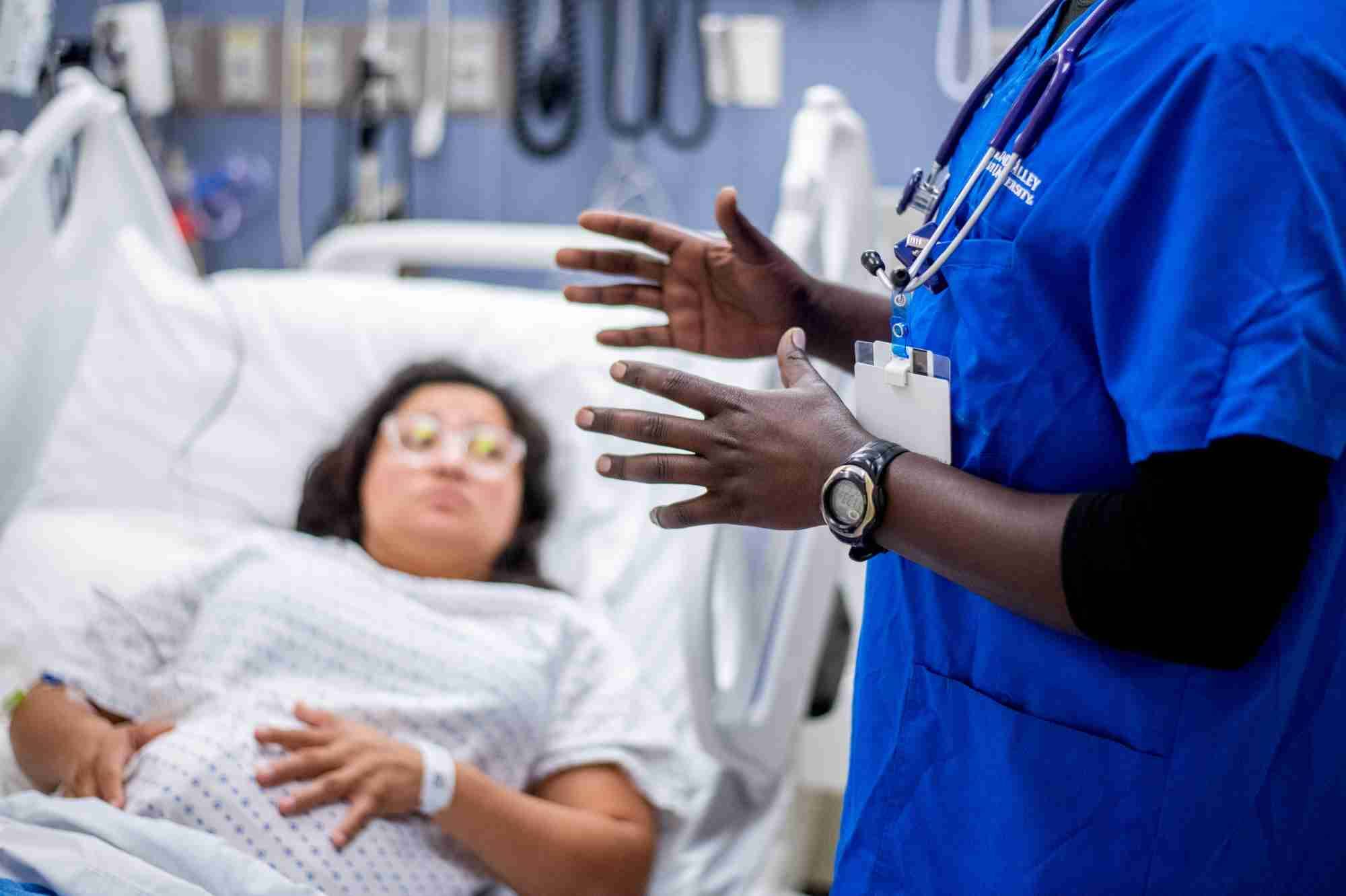 Student nurse at the bedsite